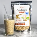 Whole grain smoothie mix beside a glass of prepared shake, labeled GrainBooster with chia, oats, and amaranth.