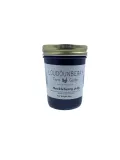 Huckleberry jam in a mason jar from Loudounberry Farm with a minimalistic white label and gold lid.