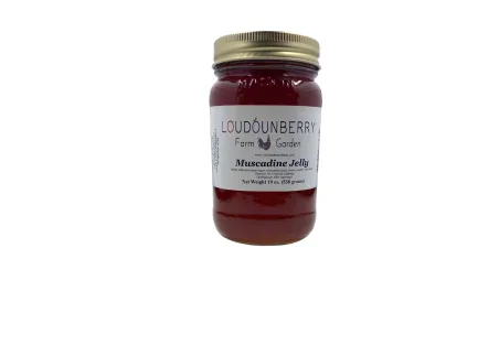 Muscadine jelly in a glass jar from Loudounberry Farm featuring deep red color and classic white label.