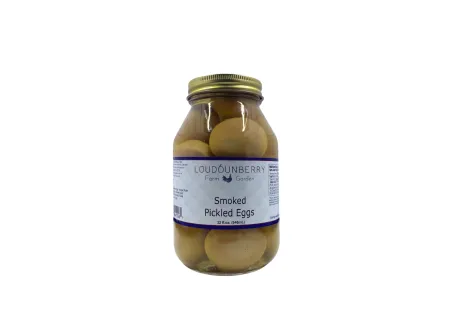 Pickled eggs in a large glass jar from Loudounberry Farm, labeled smoked and packed in brine.
